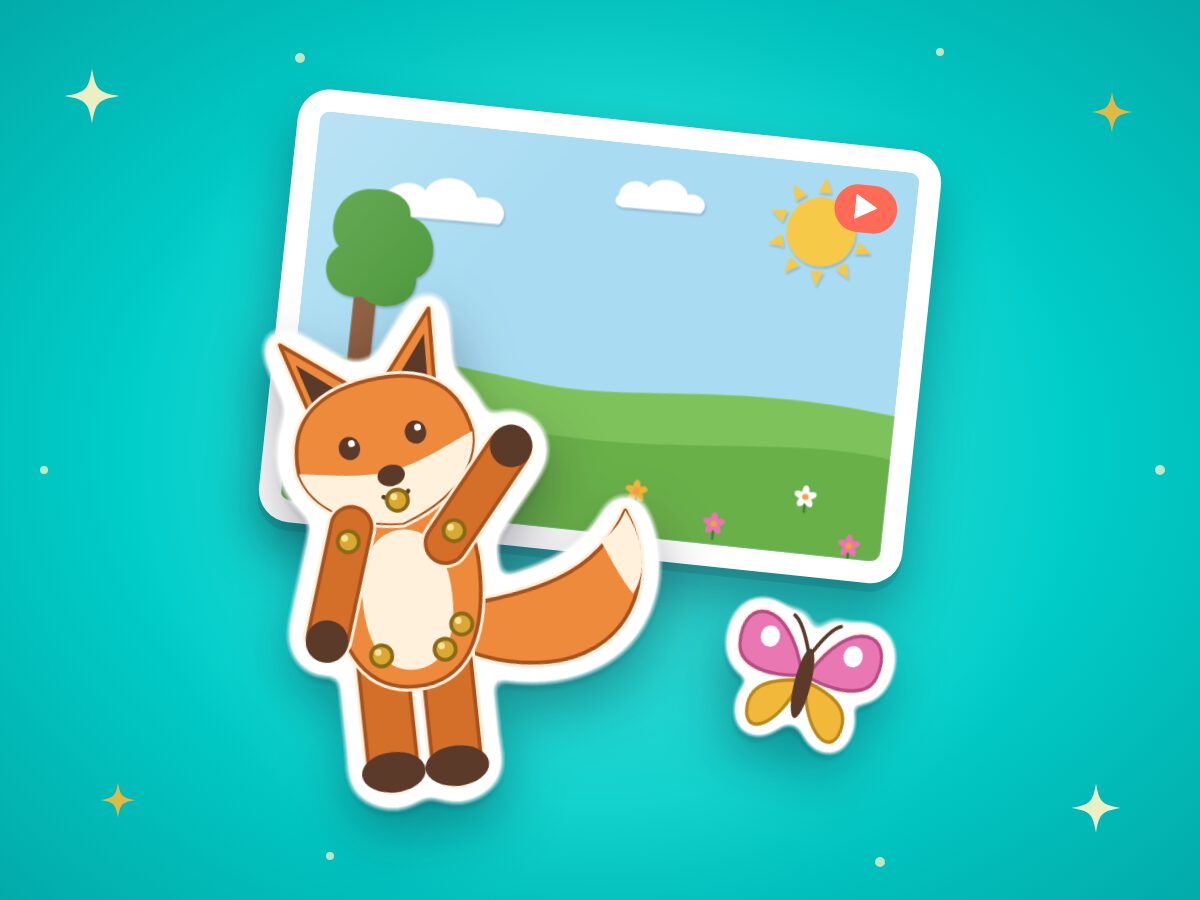 A paper cut-out fox with pinned joints, a butterfly, and its meadow stage